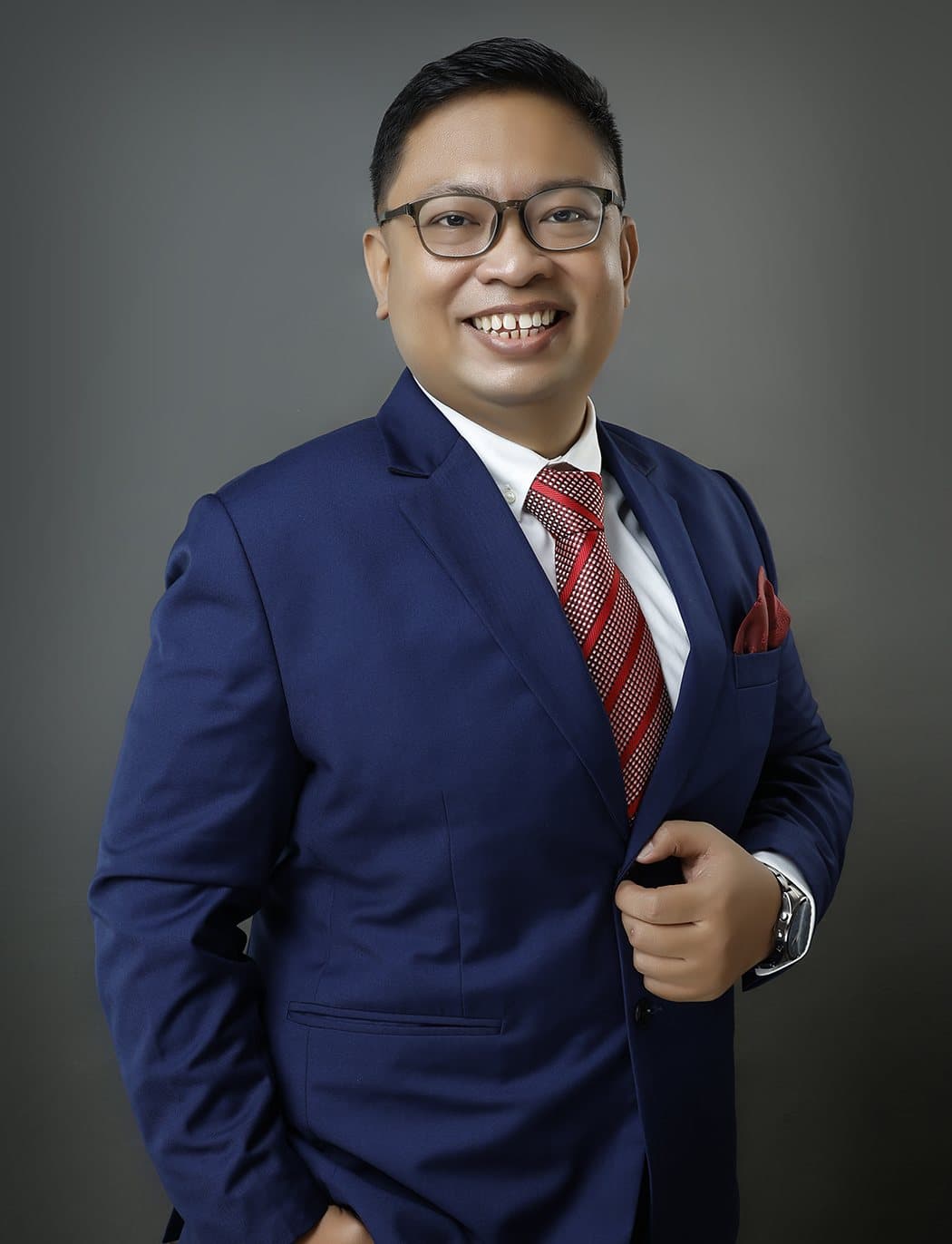 Kuya Aries Austria, life insurance and financial advisor, in a navy suit