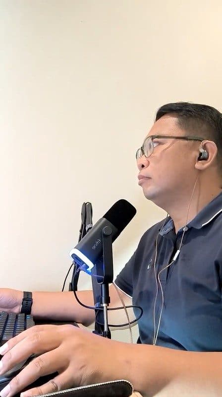 Kuya Aries recording an episode of his podcast on a studio microphone