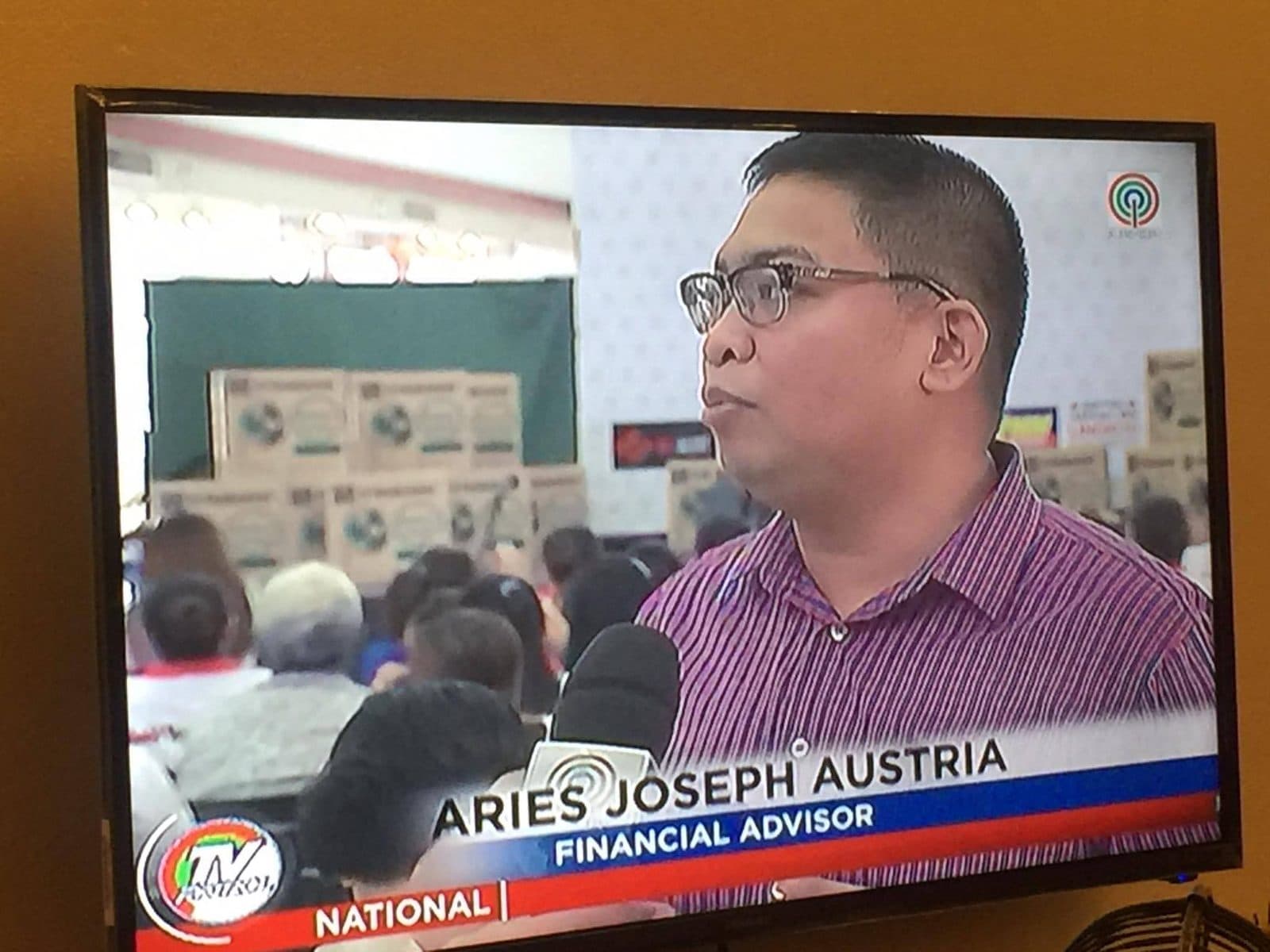 Aries Joseph Austria interviewed on national television, captioned as a financial advisor